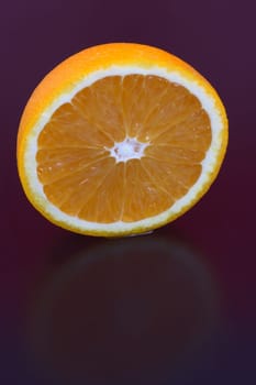 Orange and orange slices on different surfaces
