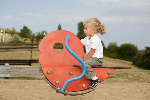 A little girl on a seesaw