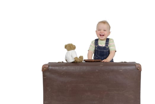 Toddler with old suitcase. South shot