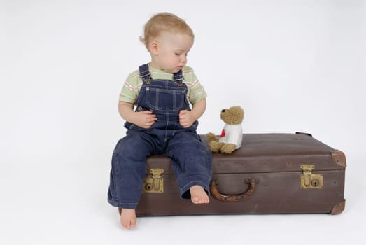 Toddler on suitcase. Studio recording
