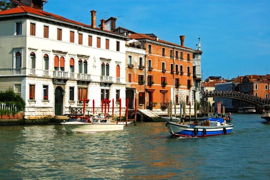 Motor boats on in the canals of Venice Italy