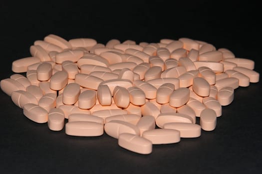 112 tablets on a black background