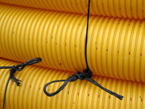 Bundled yellow conduits on a construction site