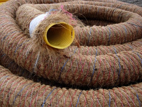 Sheathed,yellow conduit on a construction site