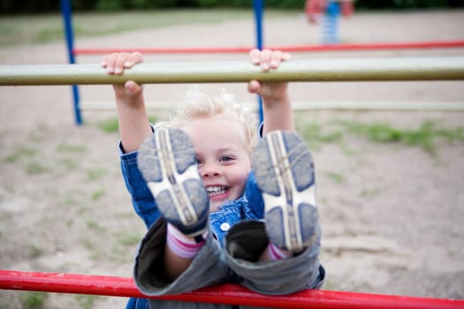 A little girl on a jungle gym