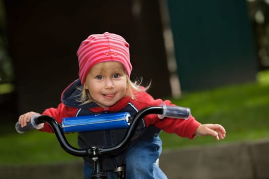 A little girl on a bicycle