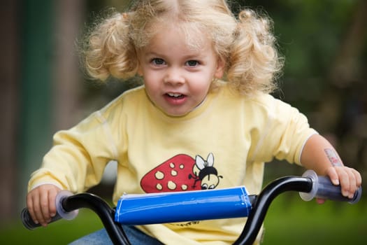 A little girl on a bicycle