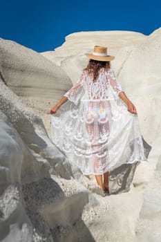 Model playing with her dress on Sarakiniko beach, Milos Island