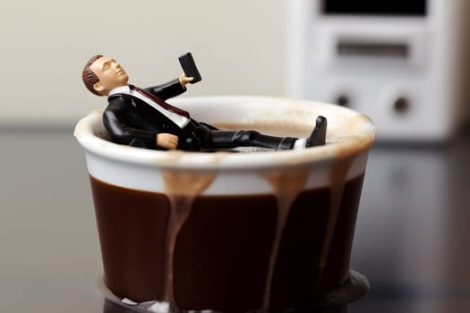 businessman figure taking bath in a cup of coffe. Neural network generated in may 2023. Not based on any actual person, scene or pattern.