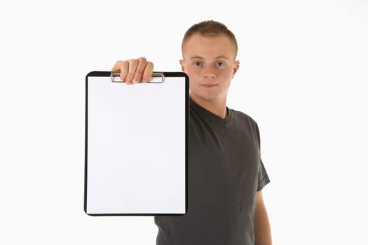 A young man holds a paper clipboard