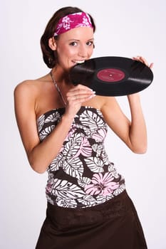 A woman bites into an LP