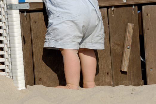 Children's legs on the beach chair
