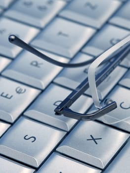 Glasses lie on a keyboard