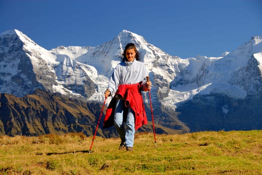 Hiking with fantastic scenery. In the background from left to right,the Eiger (Eiger North Face) 3970m,the Mönch 4107m and the Jungfrau 4158m high. The Jungfraujoch,located between the Mönch and the Jungfrau,has the highest railway station in Europe at 345