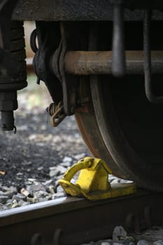Brake shoe in front of the wheel of a historic railway carriage