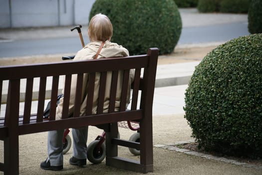 Old woman on a park bench