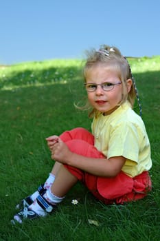 Girl 3 years sitting on meadow