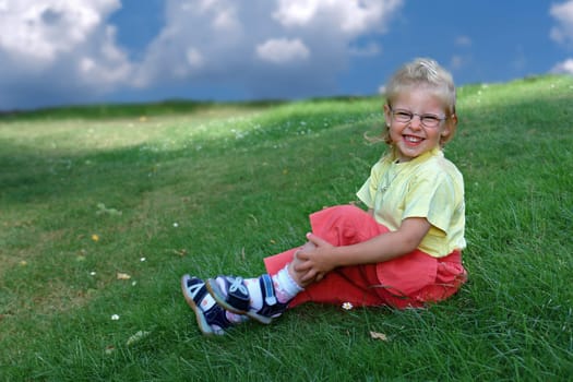 Laughing girl on summer meadow