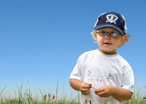Boy running over meadow motion blur