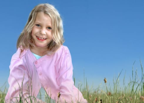Girl 6 years sitting on meadow