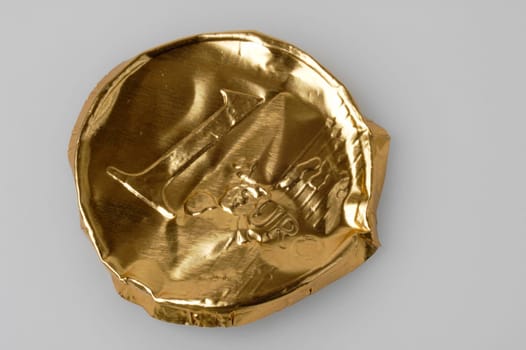 Crumpled packaging of a chocolate euro