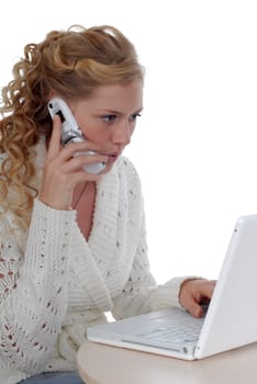 Young woman with laptop and mobile phone