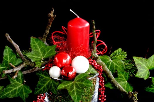 a red candle with ivy