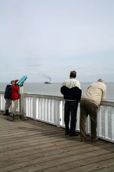 Tourists on the viewing platform at the Alte Liebe in Cuxhaven (North Sea). Here the big pots come very close to the coast on the way from/into the Elbe.