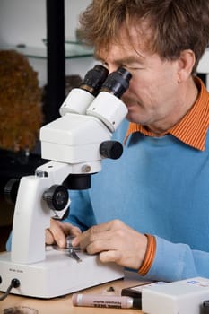 Researcher with microscope