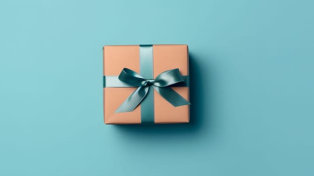 One gift box in craft wrapping paper and satin ribbon with bow on light blue clean flat surface background. Neural network generated in May 2023. Not based on any actual person, scene or pattern.