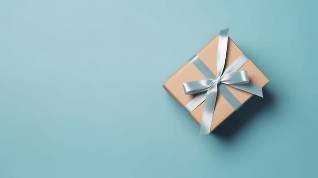 One gift box in craft wrapping paper and satin ribbon with bow on light blue clean flat surface background. Neural network generated in May 2023. Not based on any actual person, scene or pattern.