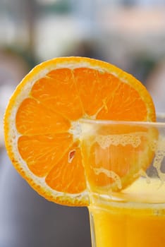 Orange cocktail in a glass on table .