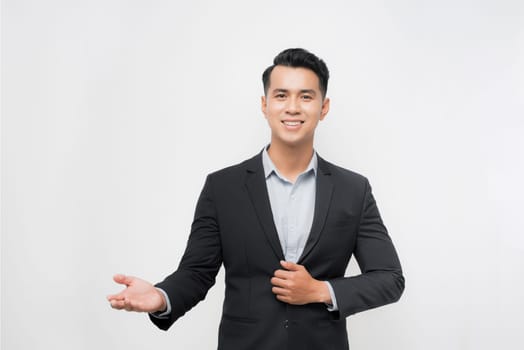 Businessman with arm out in a welcoming gesture over white background