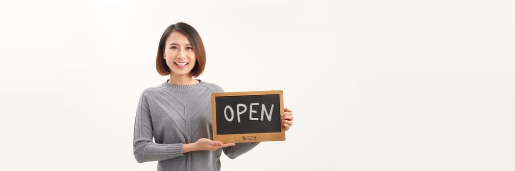 Portrait of young beautiful Asian cafe owner holding open sign. Panorama