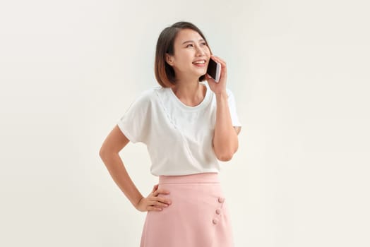 Young stylish asian woman talking on phone