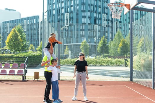 family playing basketball on court. High quality photo