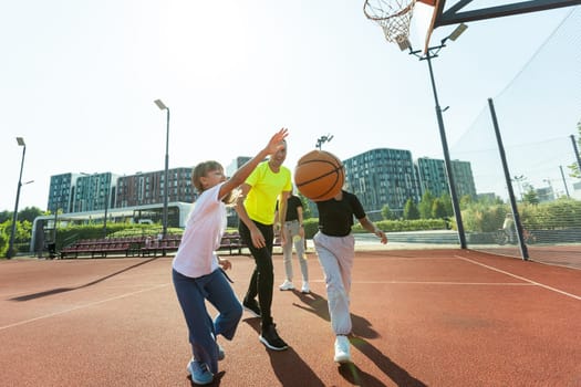 family playing basketball on court. High quality photo