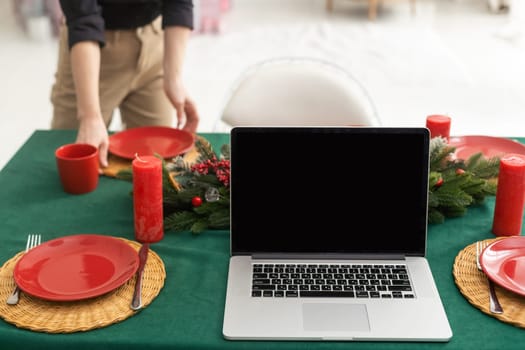 Laptop on the christmas table. Video call with the family.