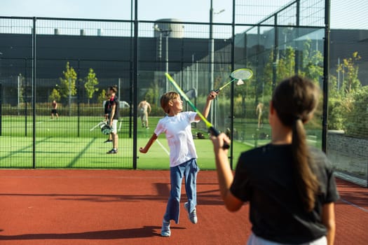 Two girls with badminton rackets on the football field. High quality photo