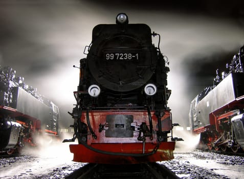 I took this picture in Wernigerode,in front of a locomotive shed. The locomotives are maintained there and are ready for the next day. The steam and backlight create beautiful effects.
