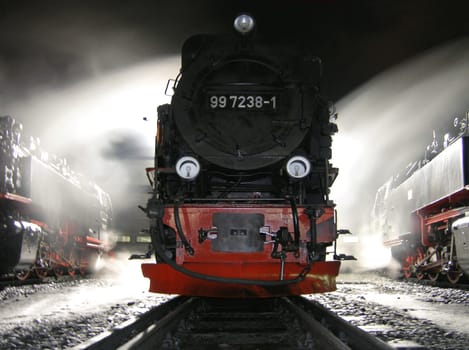 In this picture,the wind was blowing even stronger! I "straightened"" the right locomotive a bit. ( Perspective distortion ) Photographed in front of a locomotive shed of the Harz narrow-gauge railway. Approx. 6 seconds exposed."
