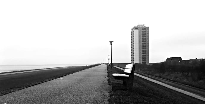 Who would come up with such a thing? A high-rise building directly behind the dike.