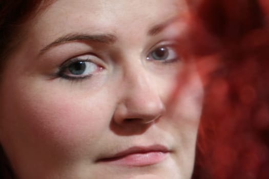 red-haired woman doing makeup
