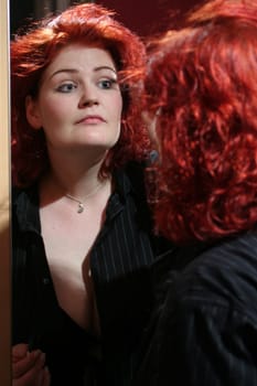 red-haired woman doing makeup