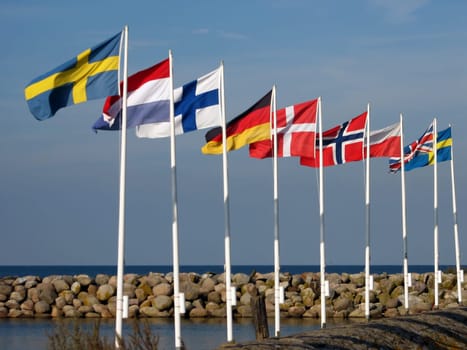 When the colorful flags are flying..... the harbour entrance of Simrishamn/Sweden. After a strong storm,the flagpoles were no longer straight.