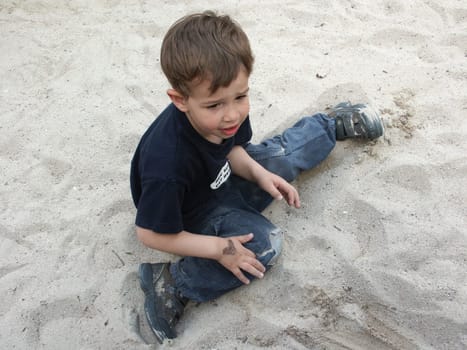 Boy playing in the sand