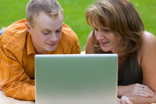 Man and woman outside at the laptop