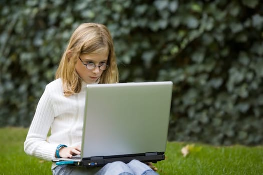 Girl with laptop outdoors
