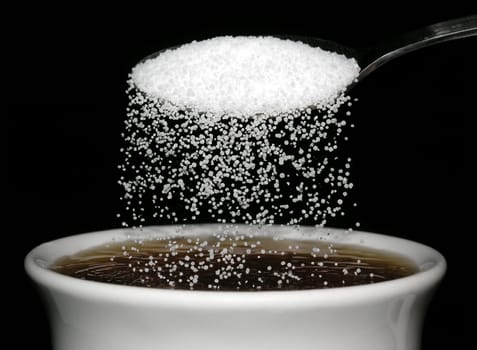 Sugar trickles into the tea