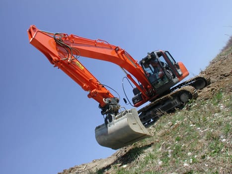 Excavator drives across the slope
